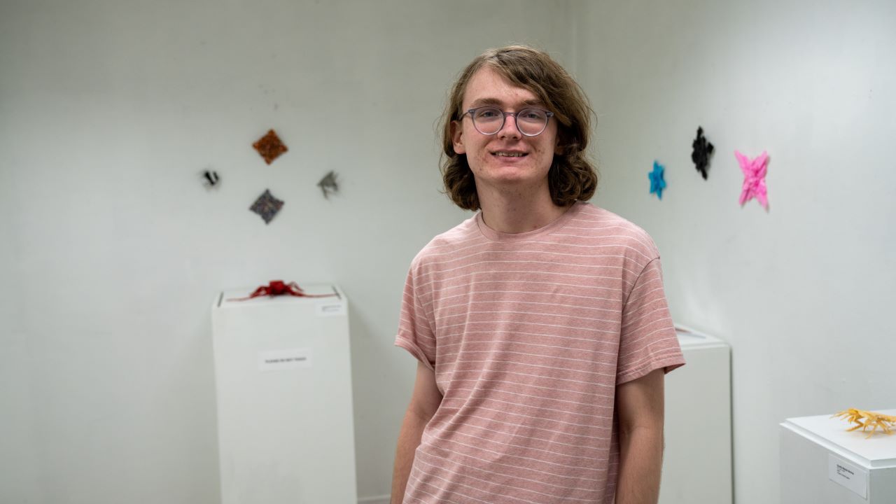 Collin Crowder with work on display in Biggin Hall